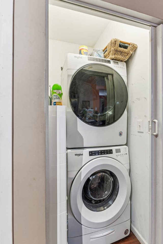 laundry area with laundry area and stacked washer / dryer