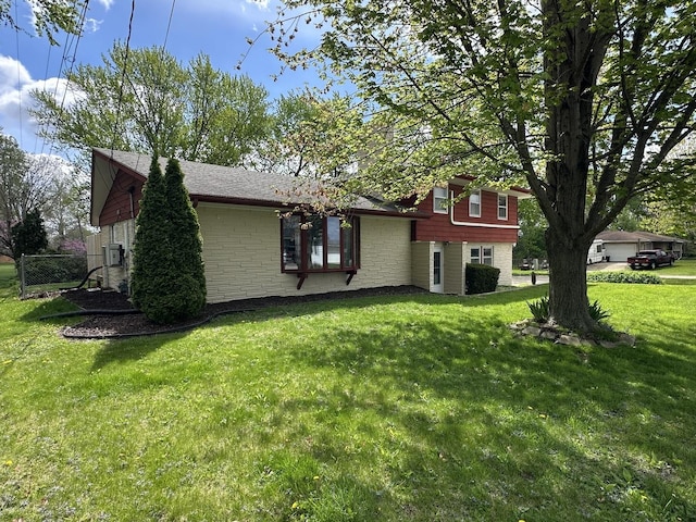 view of side of home featuring a yard and stone siding