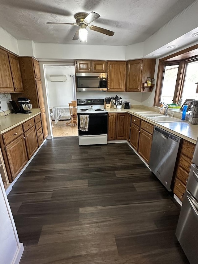 kitchen featuring light countertops, dark wood finished floors, ceiling fan, and stainless steel appliances