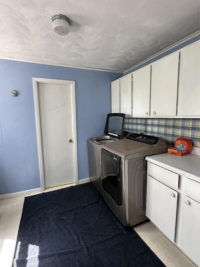 washroom featuring cabinet space and washing machine and clothes dryer