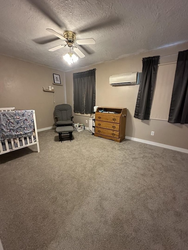 living area with an AC wall unit, a textured ceiling, ceiling fan, and baseboards