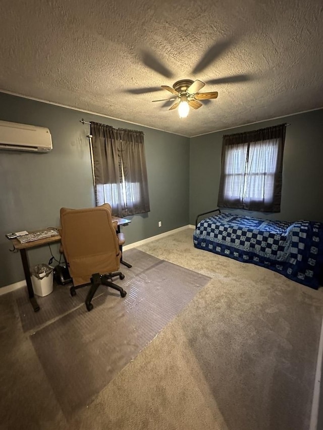 bedroom featuring carpet floors, baseboards, an AC wall unit, a textured ceiling, and a ceiling fan