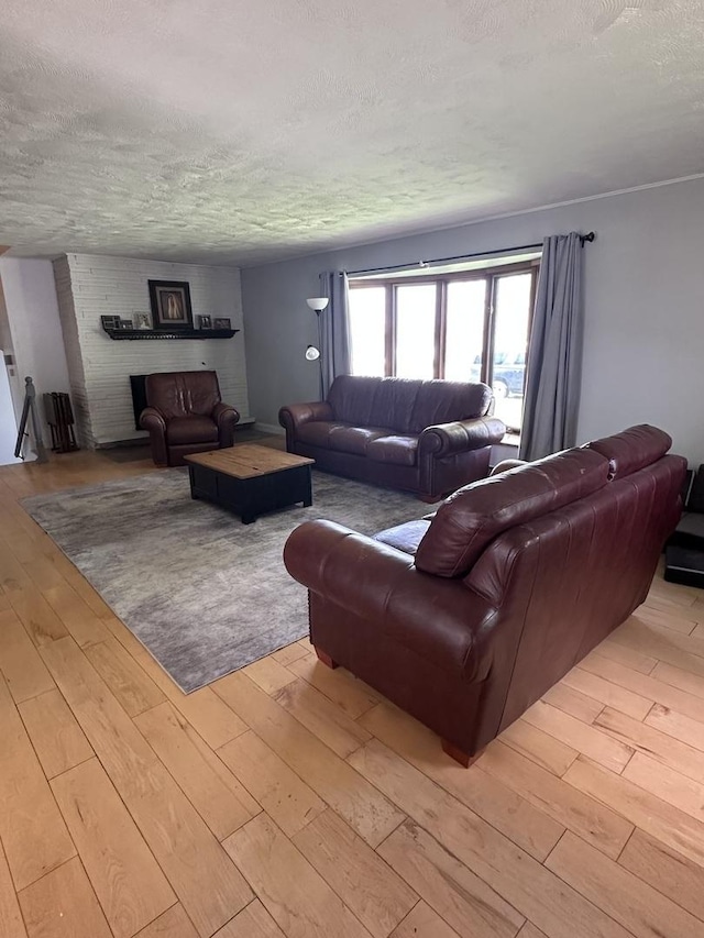 living room with light wood finished floors and a textured ceiling