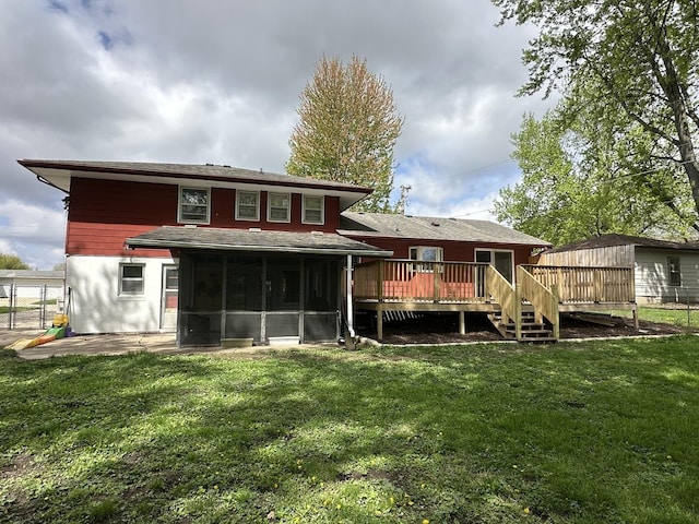 rear view of property with a sunroom, fence, a yard, and a deck