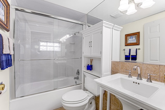 1208 Main St, Crete, IL 60417 - full bathroom featuring a sink, toilet, enclosed tub / shower combo, decorative backsplash, and visible vents