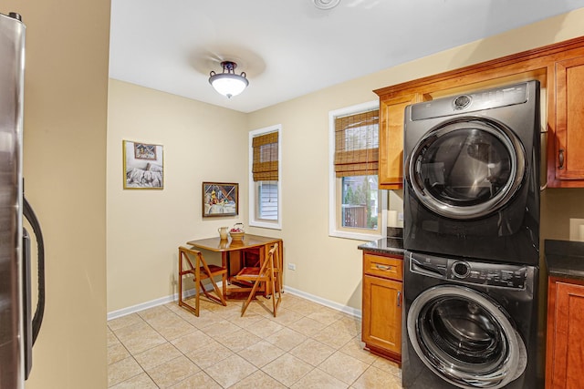 1208 Main St, Crete, IL 60417 - laundry room featuring baseboards, cabinet space, stacked washer / drying machine, and light tile patterned flooring