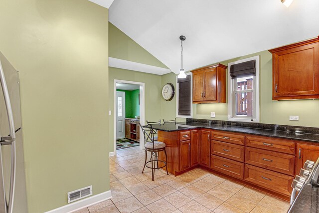 1208 Main St, Crete, IL 60417 - kitchen featuring visible vents, freestanding refrigerator, pendant lighting, a peninsula, and light tile patterned flooring