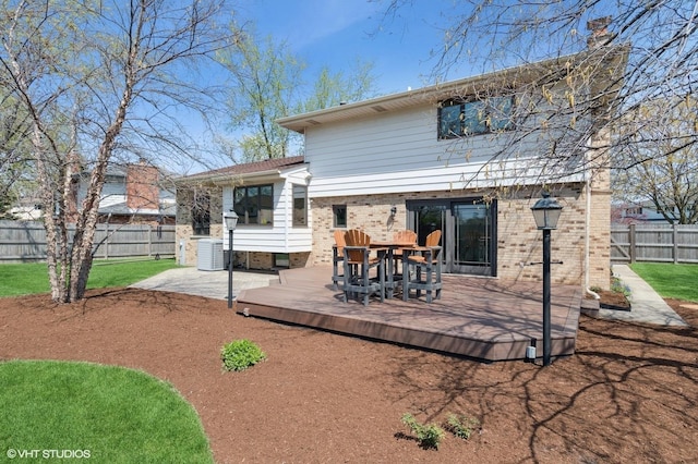 948 Weatherbee Pl, Downers Grove, IL 60516 - back of house featuring a fenced backyard, brick siding, a deck, outdoor dining space, and central AC unit