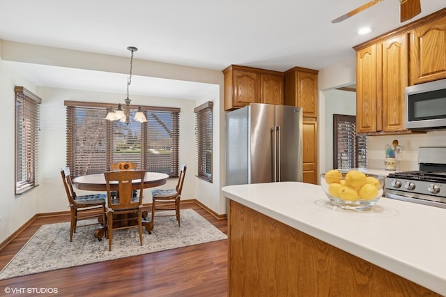 948 Weatherbee Pl, Downers Grove, IL 60516 - kitchen with appliances with stainless steel finishes, a chandelier, baseboards, light countertops, and recessed lighting