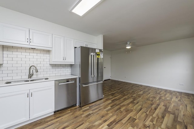 4140 Brentwood Ln, Waukegan, IL 60087 - kitchen with stainless steel appliances, a sink, light countertops, white cabinetry, and tasteful backsplash