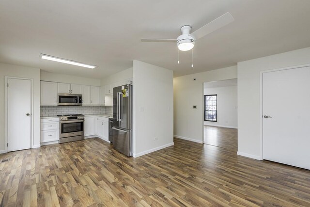 4140 Brentwood Ln, Waukegan, IL 60087 - kitchen featuring stainless steel appliances, dark wood-style floors, light countertops, ceiling fan, and tasteful backsplash