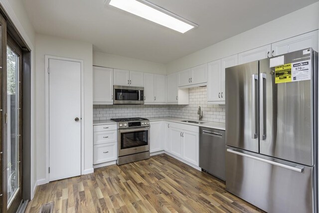 4140 Brentwood Ln, Waukegan, IL 60087 - kitchen with stainless steel appliances, a sink, light countertops, and white cabinets