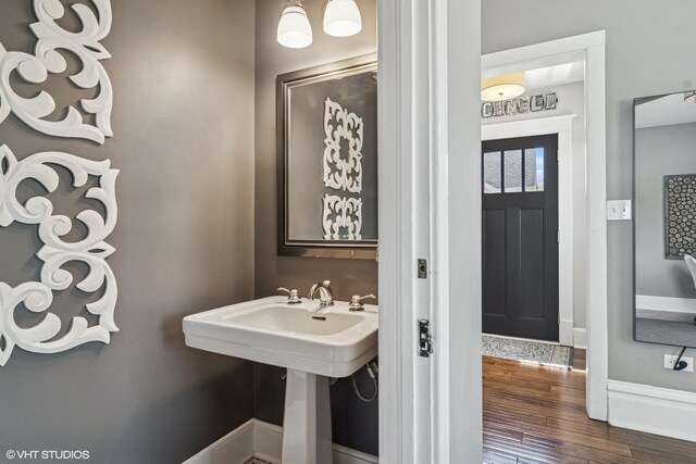 bathroom with wood finished floors and baseboards