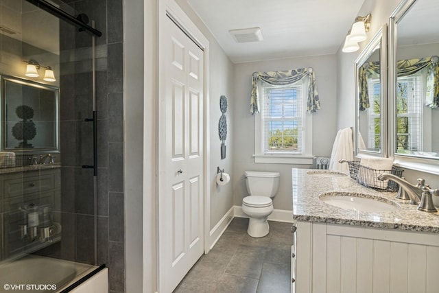 full bathroom with toilet, baseboards, double vanity, and tile patterned floors