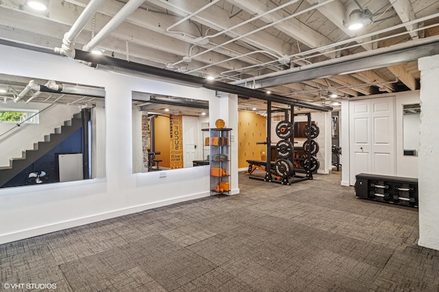 basement featuring carpet, stairway, and baseboards