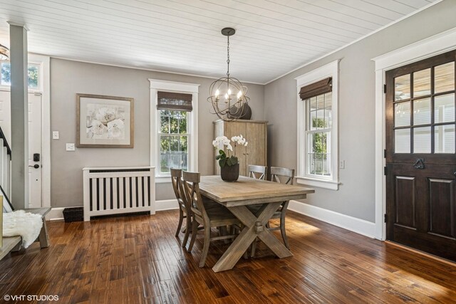 dining room with radiator, a chandelier, dark wood finished floors, plenty of natural light, and wood ceiling