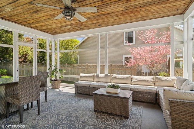 sunroom with ceiling fan and an outdoor living space