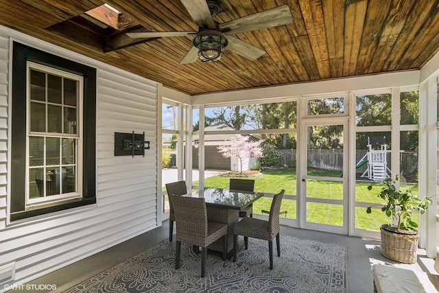 sunroom / solarium featuring outdoor dining space and ceiling fan