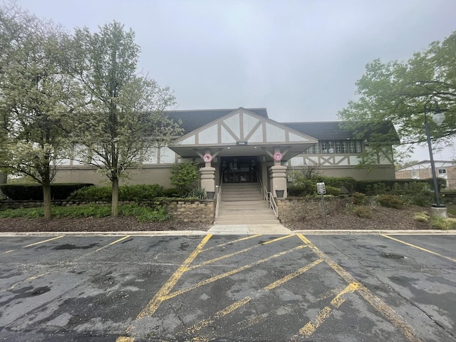 view of building exterior with uncovered parking