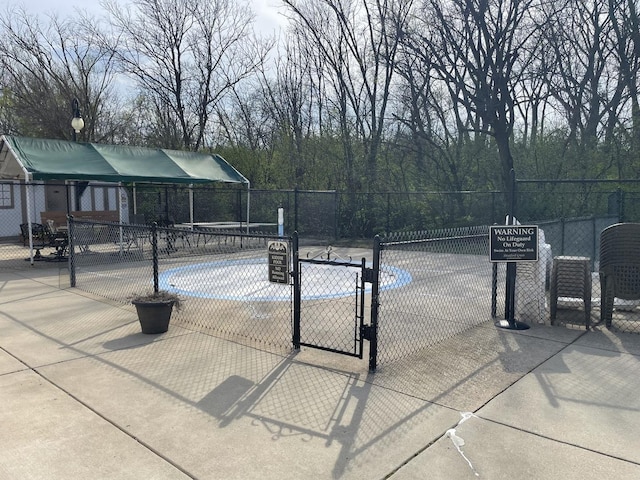 view of patio with a gate and fence