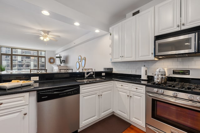 kitchen featuring a sink, white cabinetry, ceiling fan, and stainless steel appliances