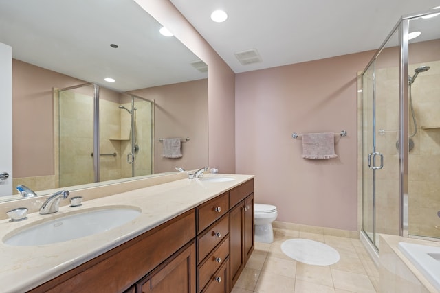 bathroom with tile patterned flooring, a sink, a stall shower, and double vanity