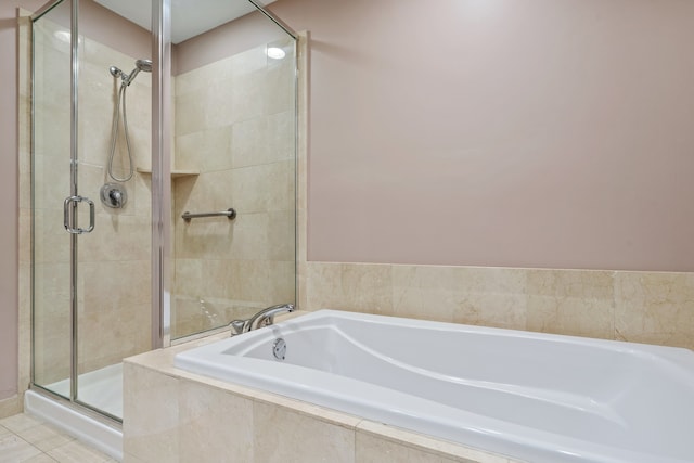 full bathroom featuring tile patterned floors, a shower stall, and a bath