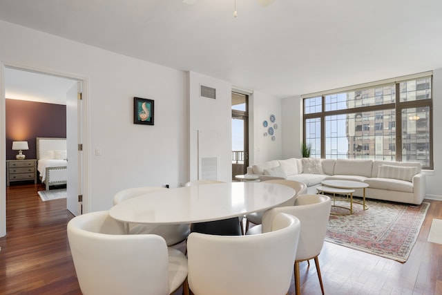 dining space with visible vents and dark wood-style flooring