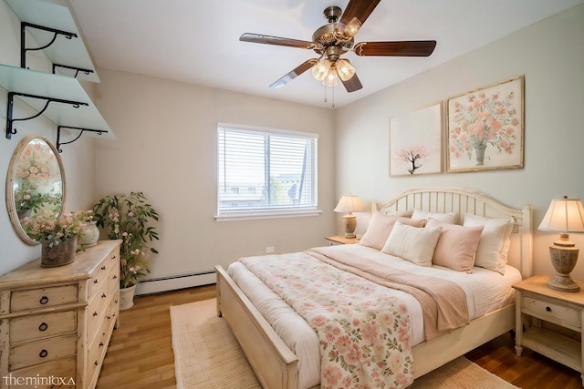 bedroom with a baseboard radiator, light wood finished floors, and a ceiling fan