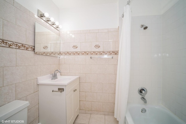 full bath featuring tile walls, toilet, vanity, shower / tub combo with curtain, and tile patterned floors