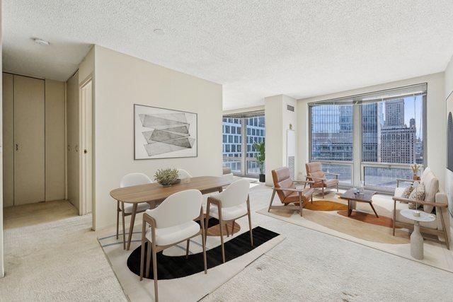 dining room featuring carpet flooring and a textured ceiling