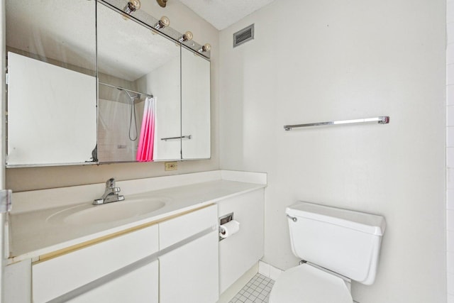 bathroom with tile patterned flooring, vanity, toilet, curtained shower, and visible vents
