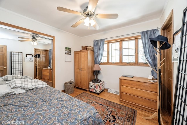 bedroom featuring wood finished floors, crown molding, and a ceiling fan