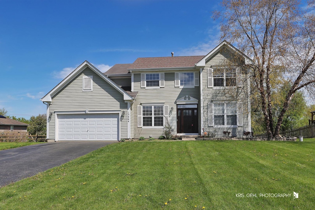 13464 W Hidden Springs Trl, Wadsworth, IL 60083 - view of front facade with driveway, fence, and a front yard