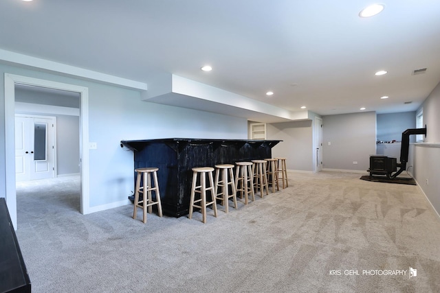 13464 W Hidden Springs Trl, Wadsworth, IL 60083 - bar featuring bar, visible vents, a wood stove, light carpet, and recessed lighting