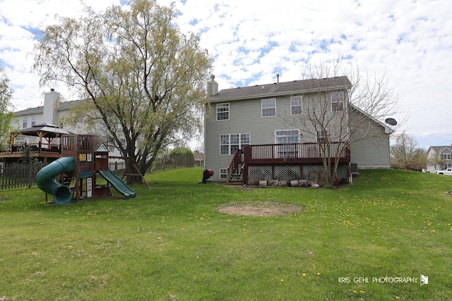 13464 W Hidden Springs Trl, Wadsworth, IL 60083 - rear view of house with fence, a yard, a wooden deck, a chimney, and a playground