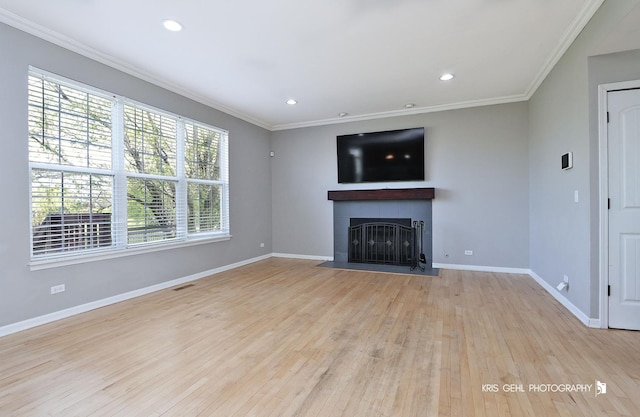 13464 W Hidden Springs Trl, Wadsworth, IL 60083 - unfurnished living room with baseboards, a tile fireplace, light wood-style flooring, and crown molding