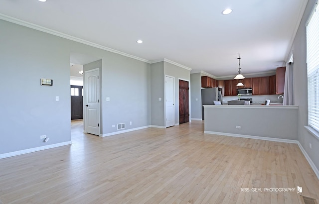 13464 W Hidden Springs Trl, Wadsworth, IL 60083 - unfurnished living room with crown molding, baseboards, light wood-type flooring, and visible vents