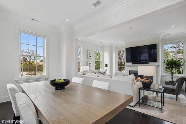 847 N Mckinley Rd, Lake Forest, IL 60045 - dining space with wood finished floors, plenty of natural light, a lit fireplace, ornamental molding, and recessed lighting