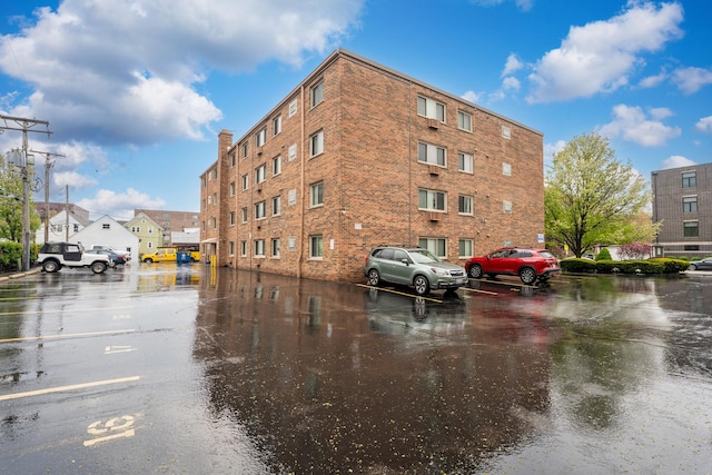 view of property featuring uncovered parking