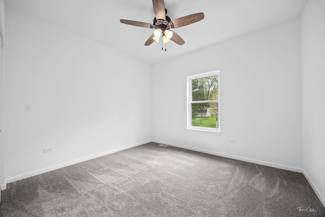 carpeted empty room featuring baseboards and ceiling fan