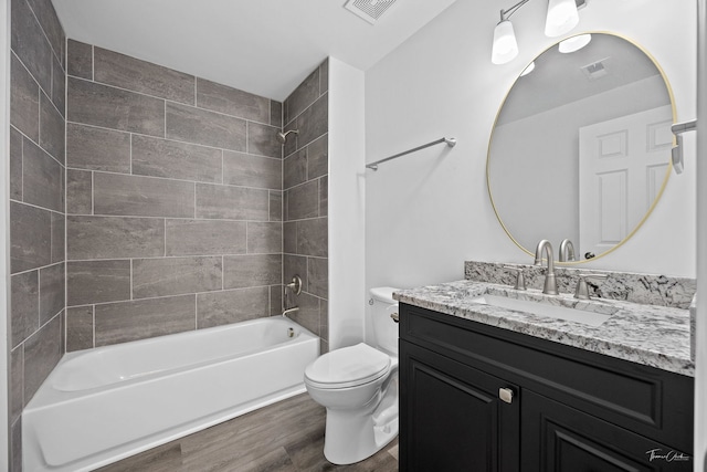 bathroom featuring wood finished floors, toilet, shower / tub combination, and vanity