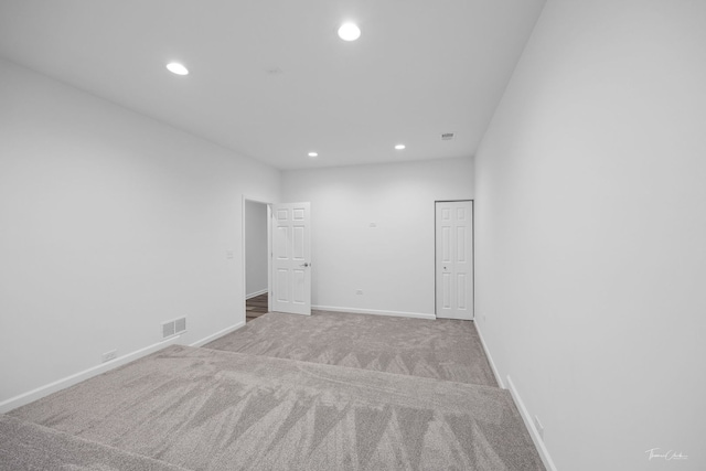 carpeted empty room featuring recessed lighting and baseboards