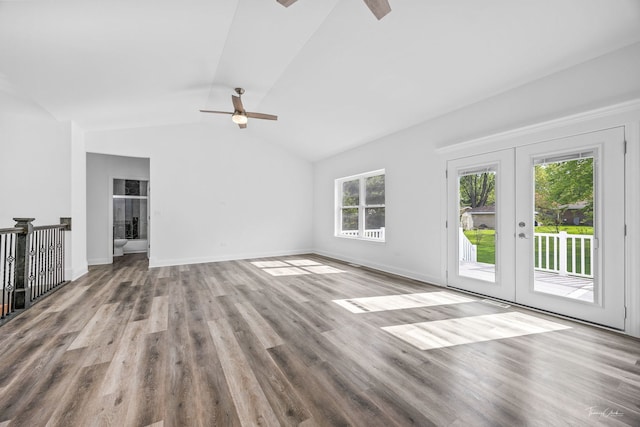 unfurnished living room with lofted ceiling, ceiling fan, wood finished floors, french doors, and baseboards