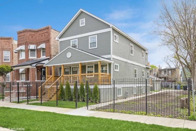 view of front of house featuring a fenced front yard and covered porch