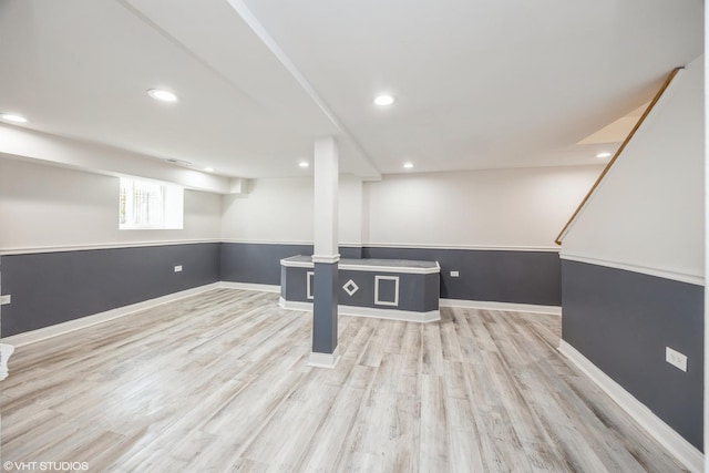 basement featuring recessed lighting, baseboards, and light wood-style floors