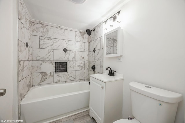 bathroom with vanity, toilet, and bathing tub / shower combination