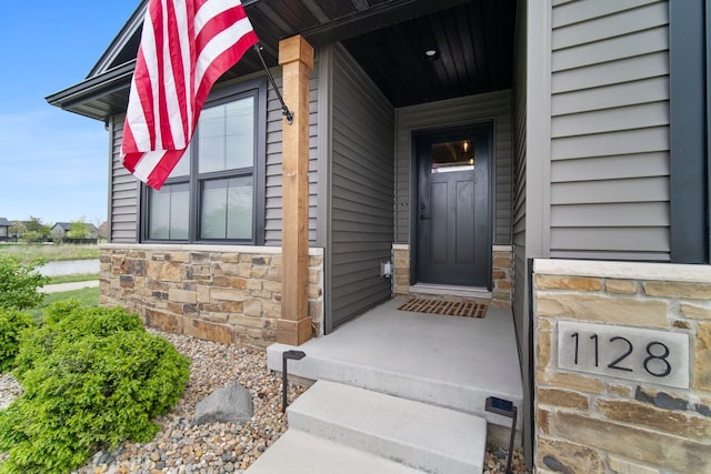 property entrance with stone siding