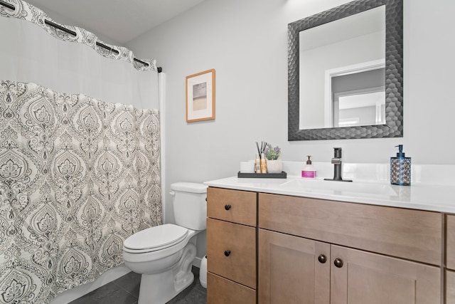bathroom with toilet, curtained shower, tile patterned flooring, and vanity