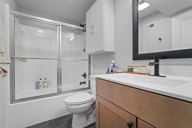 full bathroom with toilet, vanity, visible vents, tile patterned flooring, and bath / shower combo with glass door